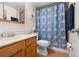 Well-maintained bathroom featuring a vanity, toilet, and shower with stylish blue patterned curtain at 2100 Ocean Shore Blvd # 1150, Ormond Beach, FL 32176