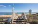 A public beach access point with wooden stairs leading to sandy shores and stunning ocean views at 2100 Ocean Shore Blvd # 1150, Ormond Beach, FL 32176