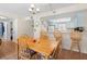 A dining area featuring a wooden table with seating for six, adjacent to a bright kitchen and cozy living space at 2100 Ocean Shore Blvd # 1150, Ormond Beach, FL 32176