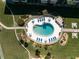 Aerial view of the kidney-shaped pool with blue lounge chairs and meticulous landscaping at 2100 Ocean Shore Blvd # 1150, Ormond Beach, FL 32176