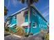 Beachfront property with teal exterior and white awnings at 2596 Tulane Ave # 4, Daytona Beach, FL 32118