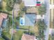 Aerial view of home with fenced backyard, in-ground pool, and a fire pit at 46 Chrysanthemum Dr, Ormond Beach, FL 32174