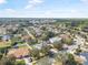 A landscape aerial view of a home in a neighborhood surrounded by lush trees at 46 Chrysanthemum Dr, Ormond Beach, FL 32174