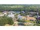 A landscape aerial view showing an in-ground pool, fenced yard, and beautiful trees at 46 Chrysanthemum Dr, Ormond Beach, FL 32174