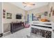 This cozy bedroom is painted in neutral colors, and includes a lofted bed, and decorative posters at 46 Chrysanthemum Dr, Ormond Beach, FL 32174