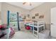 This cozy bedroom is painted in neutral colors, and includes a lofted bed, and decorative posters at 46 Chrysanthemum Dr, Ormond Beach, FL 32174