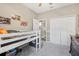 This cozy bedroom is painted in neutral colors, and includes a lofted bed, and decorative posters at 46 Chrysanthemum Dr, Ormond Beach, FL 32174