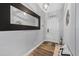 Welcoming foyer featuring wood-look floors, large decorative mirror, and a bench at 46 Chrysanthemum Dr, Ormond Beach, FL 32174