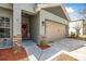 The stone pillar accents the side-entry two-car garage and the front door with a wreath at 46 Chrysanthemum Dr, Ormond Beach, FL 32174