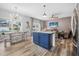 Kitchen island featuring bright blue cabinetry, stone countertops, and natural light in an open floorplan at 46 Chrysanthemum Dr, Ormond Beach, FL 32174