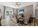 Comfortable living room with ceiling fan, plank floors, and sliding doors to outdoor pool area at 46 Chrysanthemum Dr, Ormond Beach, FL 32174