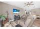 Cozy living room with a ceiling fan, plank floors, stylish furniture, and a decorative fireplace at 46 Chrysanthemum Dr, Ormond Beach, FL 32174