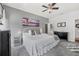 Cozy main bedroom featuring a ceiling fan, gray carpet, and access to the en-suite bathroom at 46 Chrysanthemum Dr, Ormond Beach, FL 32174