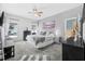 Spacious main bedroom featuring a ceiling fan, gray carpet, and great natural light from the large windows at 46 Chrysanthemum Dr, Ormond Beach, FL 32174