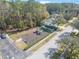 Aerial view of a neighborhood playground with green and blue playground equipment, situated by a parking area at 46 Chrysanthemum Dr, Ormond Beach, FL 32174