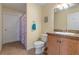 Bathroom features a single vanity, toilet and shower with seashell curtain at 5 Alamanda Dr, Ormond Beach, FL 32176