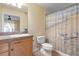 Bathroom featuring a vanity sink, toilet, and tiled shower with charming seagull-themed curtain at 5 Alamanda Dr, Ormond Beach, FL 32176