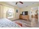 Bedroom featuring hardwood floors, a ceiling fan and a large window at 5 Alamanda Dr, Ormond Beach, FL 32176