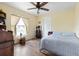 Bedroom featuring hardwood floors, ceiling fan, window and neutral paint at 5 Alamanda Dr, Ormond Beach, FL 32176