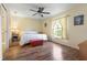 Comfortable bedroom featuring hardwood floors, a ceiling fan and a large window at 5 Alamanda Dr, Ormond Beach, FL 32176