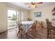 Open dining area featuring wood floors, a ceiling fan and sliding glass door to the outdoor patio at 5 Alamanda Dr, Ormond Beach, FL 32176