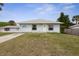 Charming single-story home with a well-maintained lawn and unique dolphin artwork at 5 Alamanda Dr, Ormond Beach, FL 32176