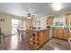 Bright kitchen featuring wood floors, a central island, light wood cabinets and a sliding door to the patio at 5 Alamanda Dr, Ormond Beach, FL 32176