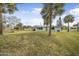 Ranch-style home with palm trees and a spacious yard at 55 Neptune Ave, Ormond Beach, FL 32176