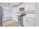 Modern kitchen with white cabinets and stainless steel appliances at 55 Neptune Ave, Ormond Beach, FL 32176