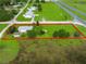 Large lot, outlined in red, features a house, outbuilding, RV and a wooden fence at 6680 Se 174Th Ln, Summerfield, FL 34491