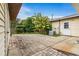 Brick patio, with an AC unit and tropical foliage in the backyard at 6680 Se 174Th Ln, Summerfield, FL 34491