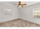 Bright bedroom features wood-look flooring and natural light from the windows at 6680 Se 174Th Ln, Summerfield, FL 34491