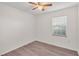 Bright bedroom features wood-look flooring and natural light from the window at 6680 Se 174Th Ln, Summerfield, FL 34491