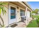 Charming front porch with a bench and decorative door, offering a welcoming curb appeal at 6680 Se 174Th Ln, Summerfield, FL 34491