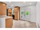 Bright kitchen featuring a stainless steel sink, tiled floor, and ample cabinet space at 6680 Se 174Th Ln, Summerfield, FL 34491