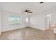 Open living room with tile flooring, ceiling fan and natural light at 6680 Se 174Th Ln, Summerfield, FL 34491