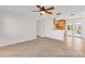 Open living room area featuring a ceiling fan and tile flooring with a kitchen view at 6680 Se 174Th Ln, Summerfield, FL 34491