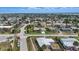 Aerial shot of a neighborhood with mature landscaping, diverse home styles, and proximity to the coast at 100 Lynnhurst Dr, Ormond Beach, FL 32176