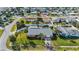 Bird's eye view of the house in a quiet neighborhood with palm trees and fenced yards at 100 Lynnhurst Dr, Ormond Beach, FL 32176