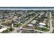 An aerial view captures a waterfront residential neighborhood featuring a mix of home styles and mature trees at 100 Lynnhurst Dr, Ormond Beach, FL 32176