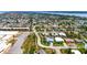 An aerial view of a residential neighborhood showcasing tree-lined streets and diverse home styles near a body of water at 100 Lynnhurst Dr, Ormond Beach, FL 32176