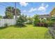 A spacious backyard with a well-maintained lawn, mature trees, and a garden providing a private outdoor space at 100 Lynnhurst Dr, Ormond Beach, FL 32176