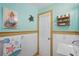 Unique bathroom featuring calming seafoam walls, white wainscoting, and decorative turtle and shell decor at 100 Lynnhurst Dr, Ormond Beach, FL 32176