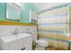 Bathroom featuring a pedestal sink, a decorative shower curtain, and a medicine cabinet at 100 Lynnhurst Dr, Ormond Beach, FL 32176