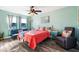 Bedroom featuring a pullout sofa, ceiling fan, large window, and accent chair at 100 Lynnhurst Dr, Ormond Beach, FL 32176