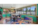 Unique sunroom turned dining room featuring a full bar, ocean decor, and lots of bright light at 100 Lynnhurst Dr, Ormond Beach, FL 32176