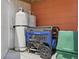 Image of a generator with two white propane tanks secured to the wall in an outdoor location at 100 Lynnhurst Dr, Ormond Beach, FL 32176