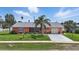 Welcoming home with lush green lawn, decorative plants, and a well-maintained exterior at 100 Lynnhurst Dr, Ormond Beach, FL 32176
