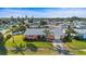 Aerial view of a cozy home featuring a well-kept lawn, a garage, and mature trees at 100 Lynnhurst Dr, Ormond Beach, FL 32176