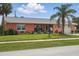 Inviting home with a beautiful lawn, mature landscaping, and a 'For Sale' sign at 100 Lynnhurst Dr, Ormond Beach, FL 32176